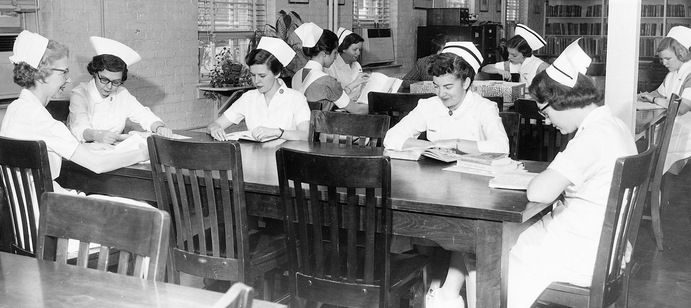 Nurses studying in a UVA library in uniform.