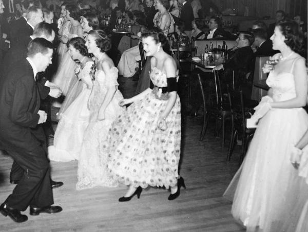 Senior nursing students and their physician escorts maneuver through the curtsies and bows of the Virginia Reel.	Lorraine Bowers Albrecht (DIPLO 1951) donation to the ECBCNHI. Eleanor Crowder Bjoring Center for Nursing Historical Inquiry, University of Virginia School of Nursing.