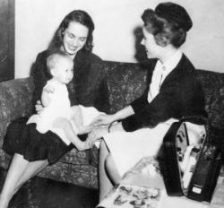 Mother and baby enjoy a community health nursing home care visit.	School of Nursing Catalog, The Record, 1963-64.